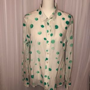 White blouse with green accent.